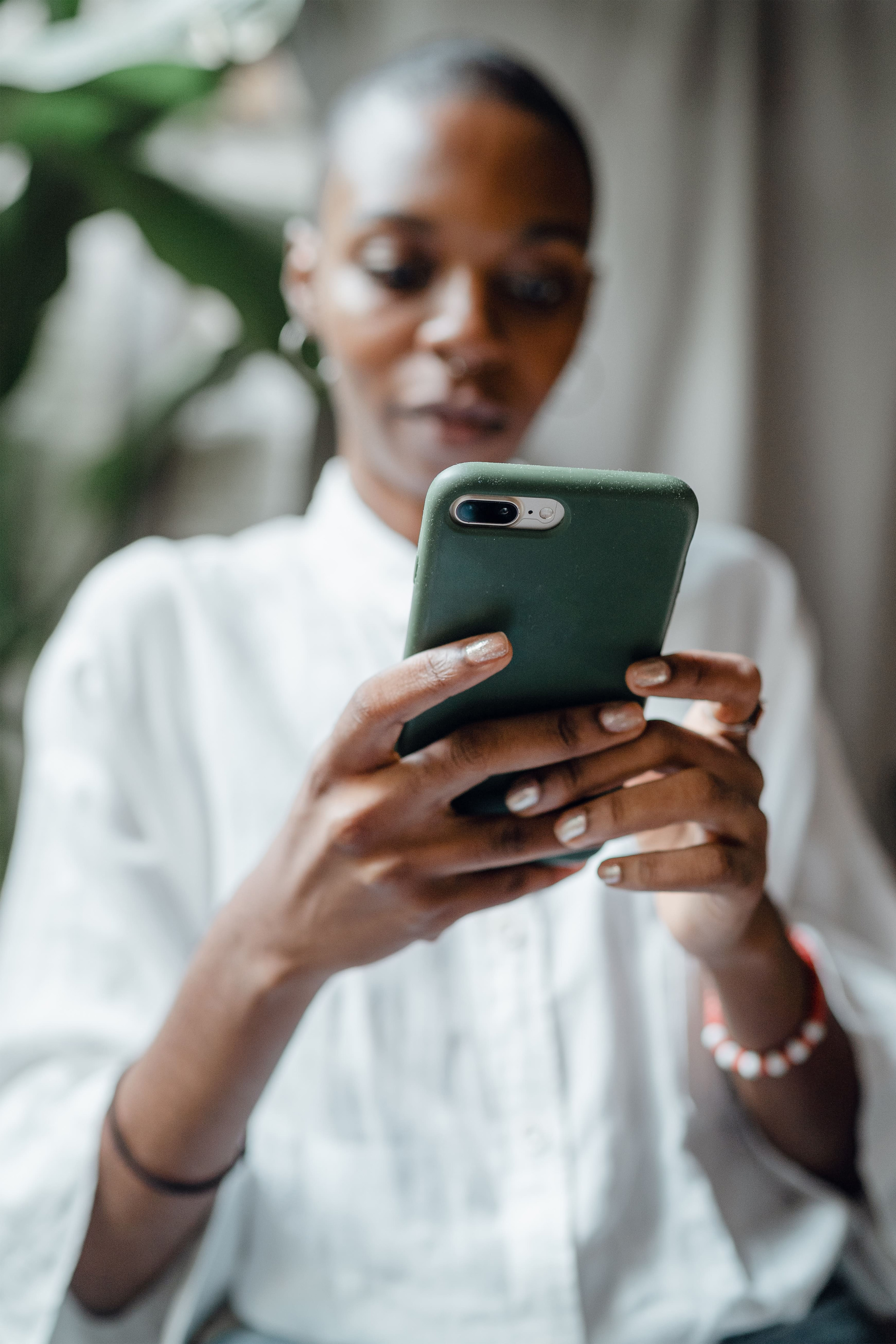 woman looking at Beam app platform on phone