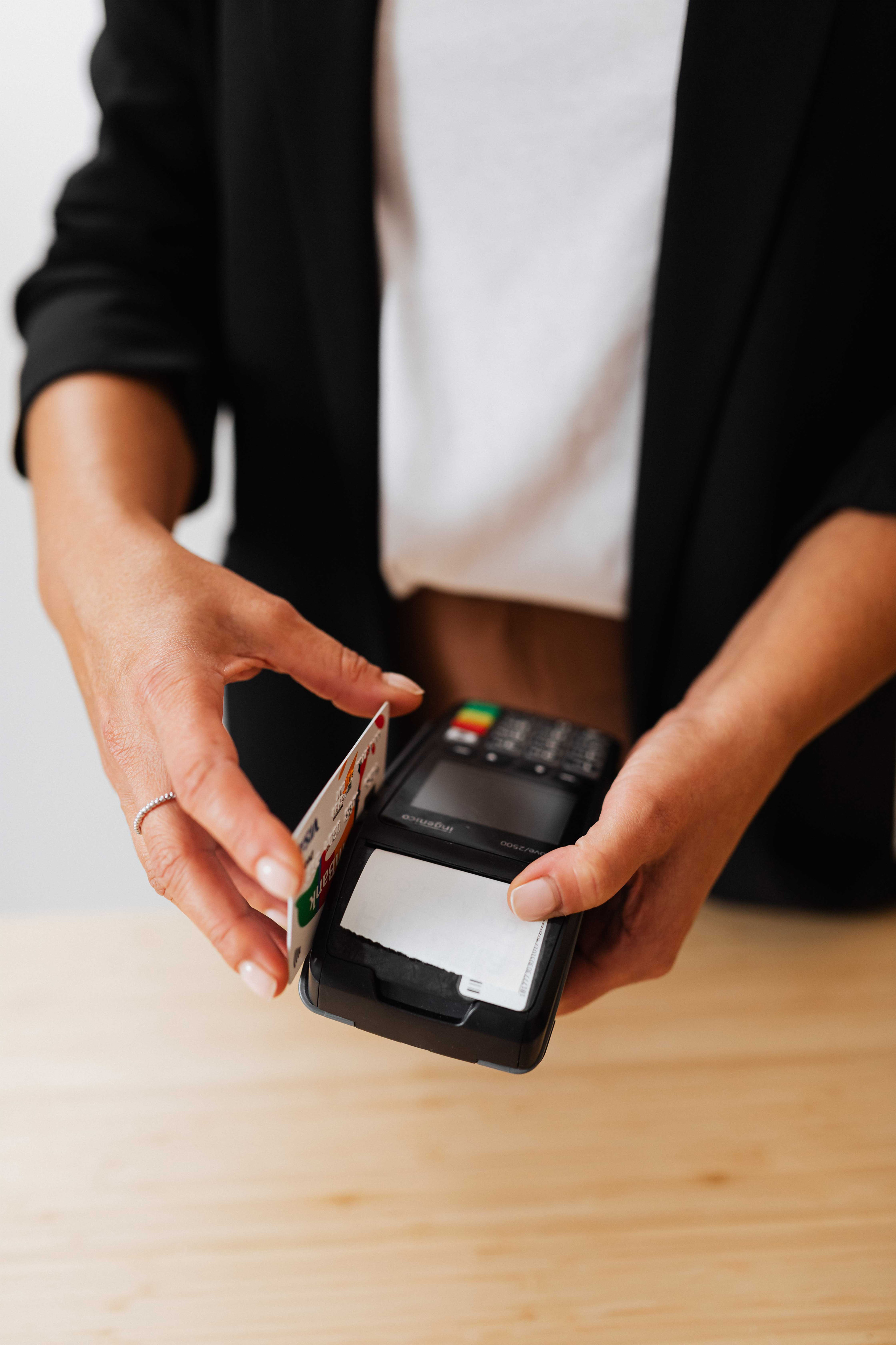 woman using debit card provided by beam for partner distributed cash