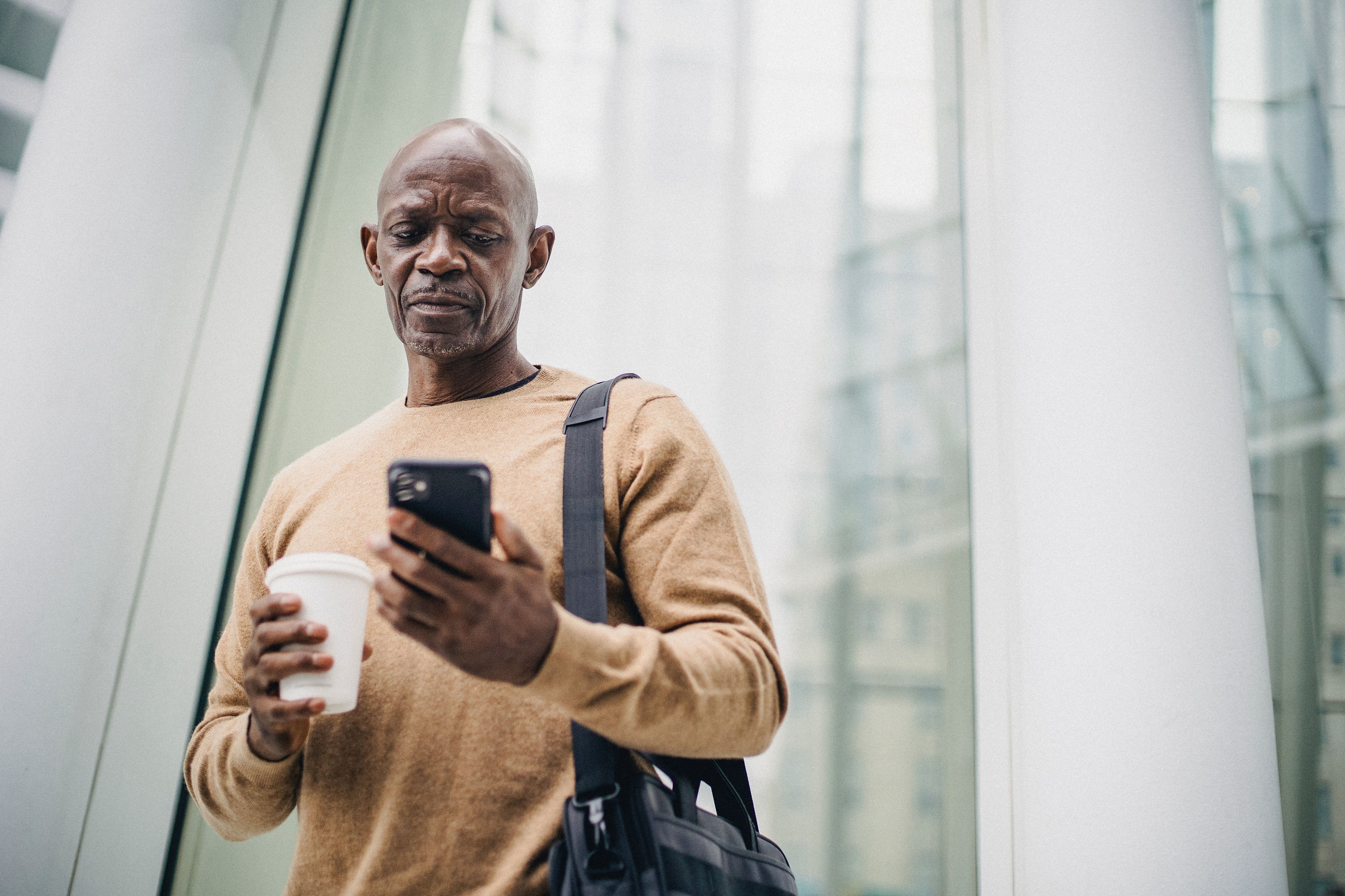 man looking at Beam app platform on phone