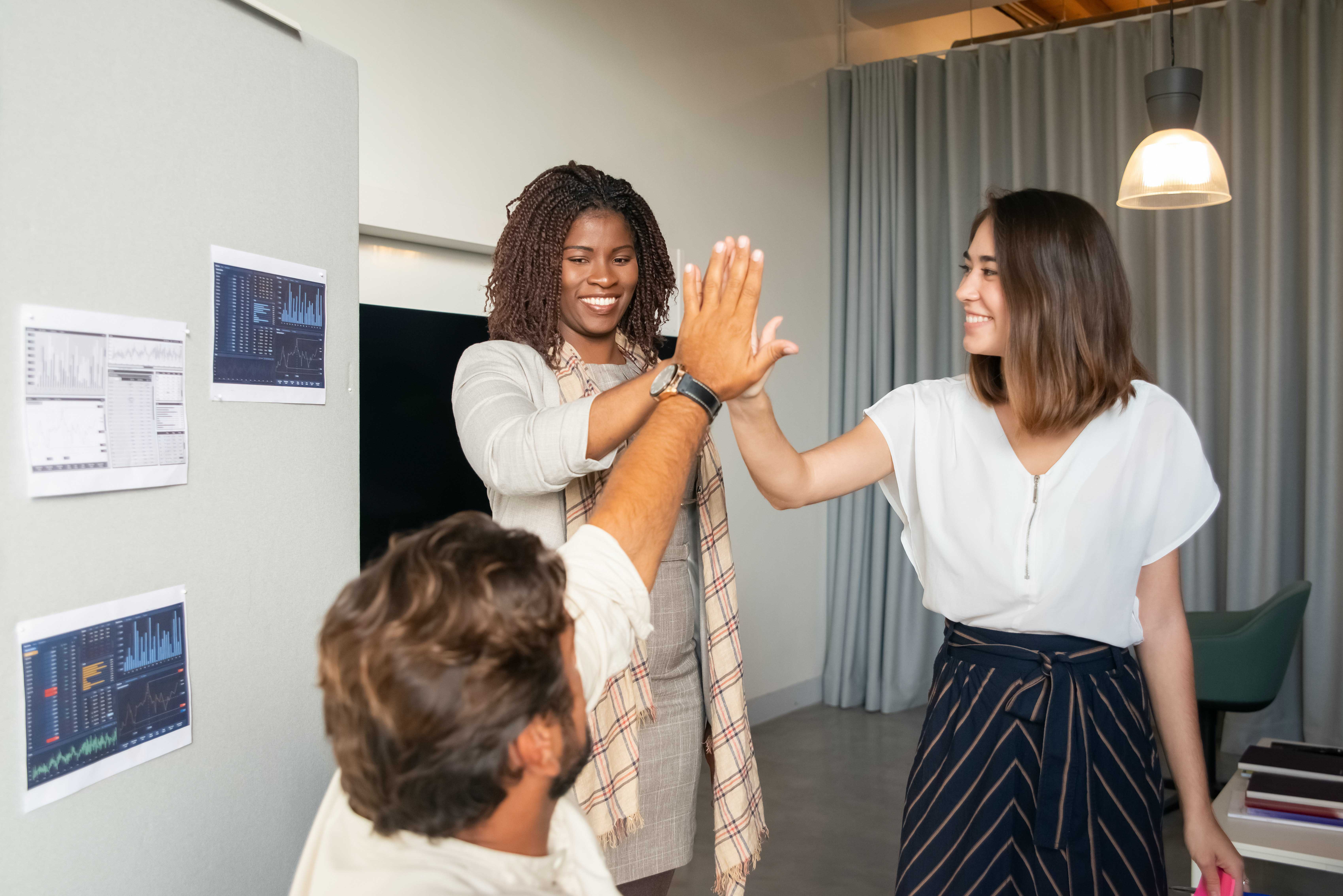 collaborative group of diverse workforce high fiving