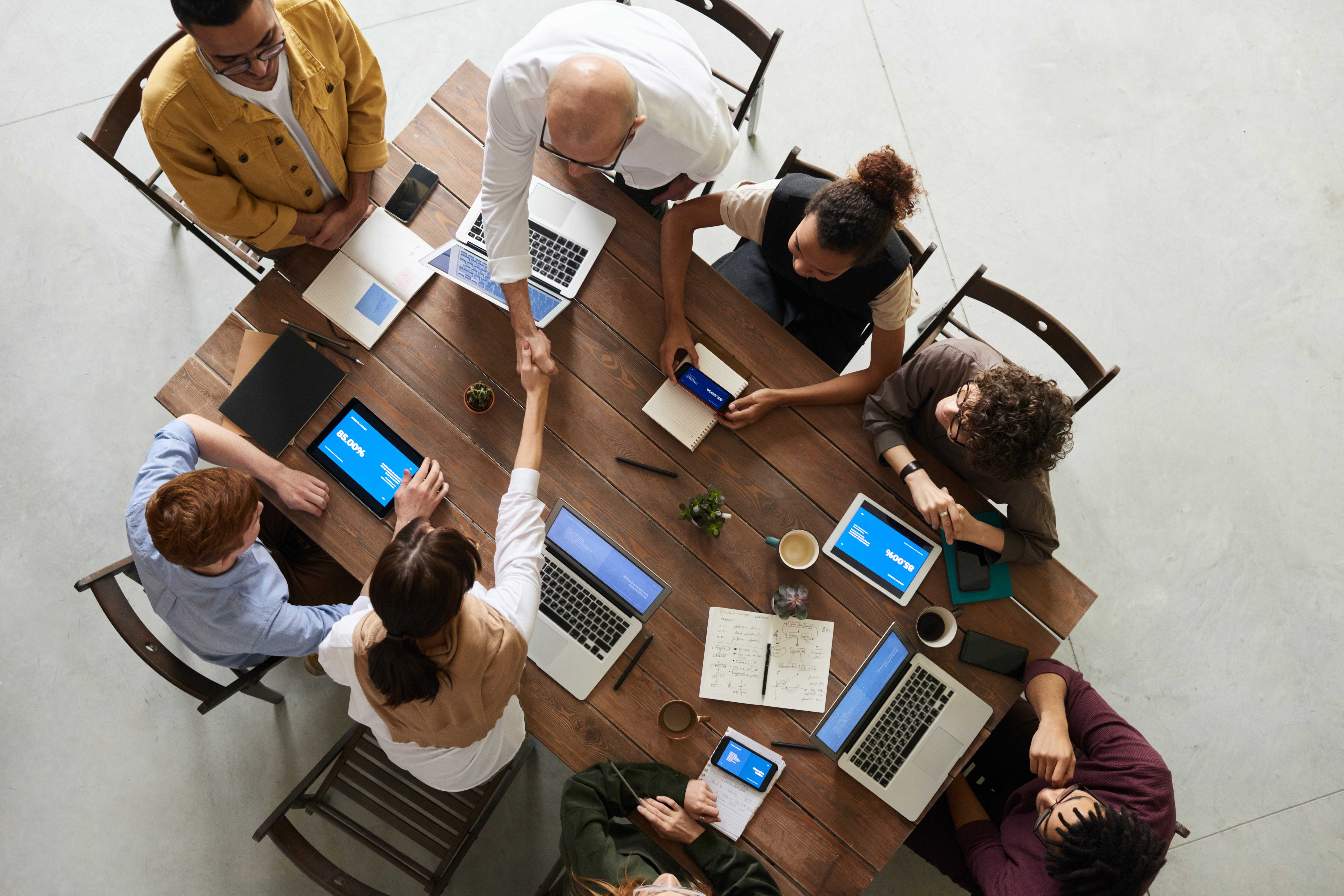 collaborative group of diverse workforce around computers